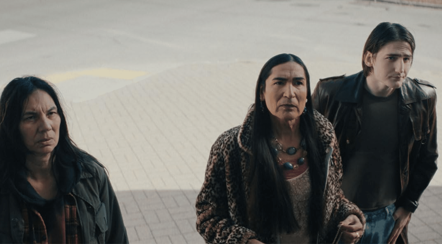 Still from the film Aberdeen. Shows three people standing while looking slightly up at something or someone.