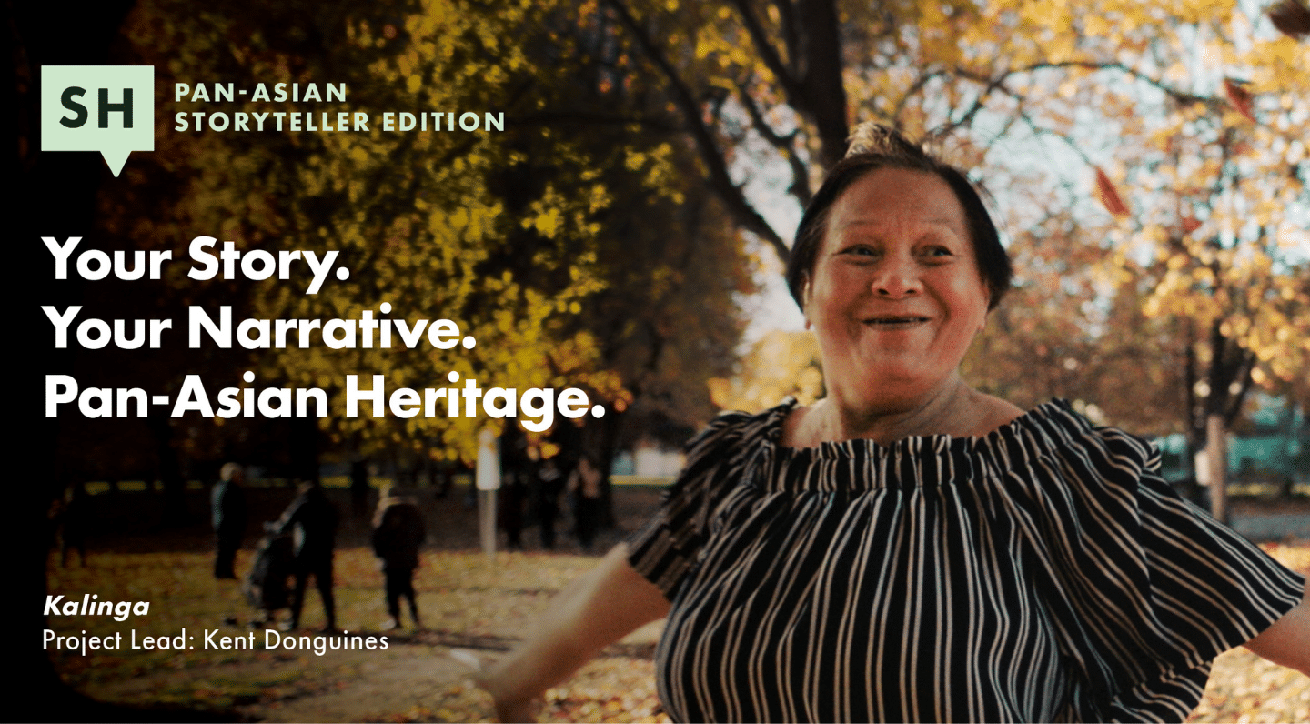 Promotional image for the "Pan-Asian Storyteller Edition" of TELUS STORYHIVE. On the left, white text reads: “Your Story. Your Narrative. Pan-Asian Heritage.” Below it is the title “Kalinga” with a note that the project lead is Kent Donguines. On the right, a joyful older woman with short dark hair and wearing a black-and-white striped top extends her arm, smiling in a park filled with golden autumn leaves. In the background, people walk among tall trees. The STORYHIVE logo appears at the top left.